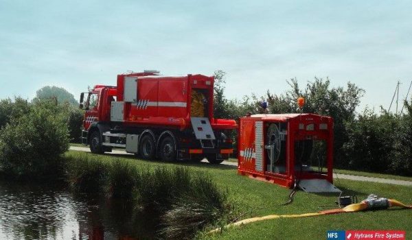 HYTRANS hose layering and recovery unit deployed near a river