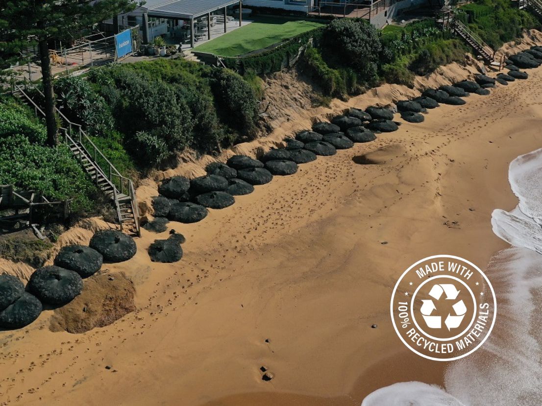 The first row of Kyowa Rock Bags on Wamberal beach naturally covered.